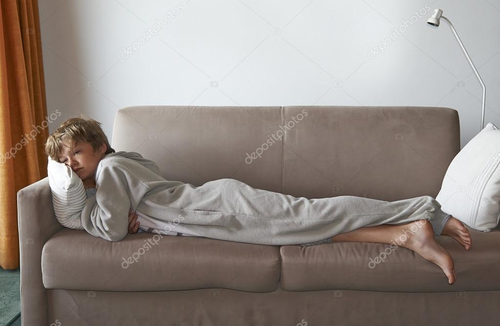 Boy watch television program on sofa Stock Photo Bombaert 117688020