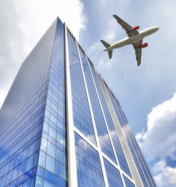 Düşük ofis binası üzerinde uçan jet uçağı