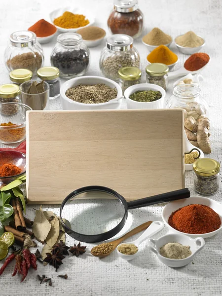 Spices and blank wooden board — Stock Photo, Image