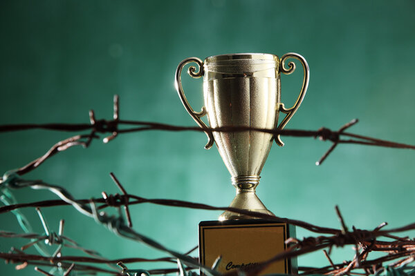 Golden trophy in barbwire
