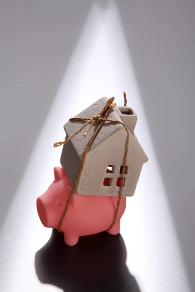 Piggy bank and model house — Stock Photo, Image
