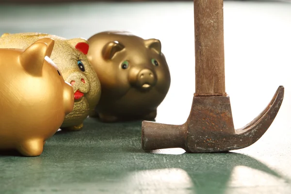 Piggy banks and hammer — Stock Photo, Image