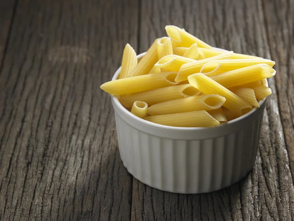 Dry pasta on table — Stock Photo, Image