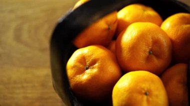 Bir sepet mandalina ve Çin Yeni Yıl Festivali süslemeleri, kırmızı paket, erik çiçeği, Ingot ve kırmızı arka planda fener..