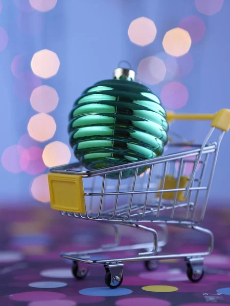 Shopping cart with christmas  ball — Stock Photo, Image