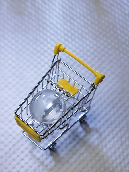 Glass globe on shopping cart. — Stock Photo, Image