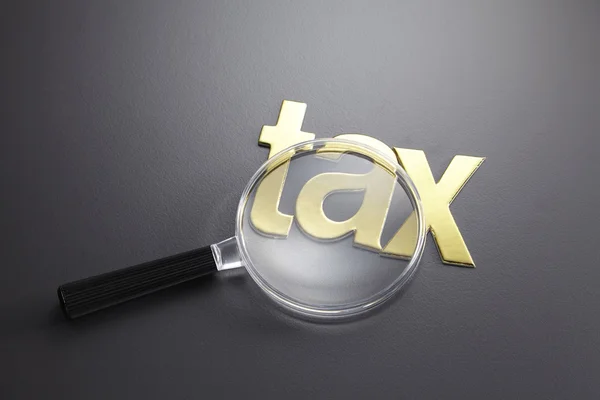 Alphabet tax and the magnifying glass — Stock Photo, Image