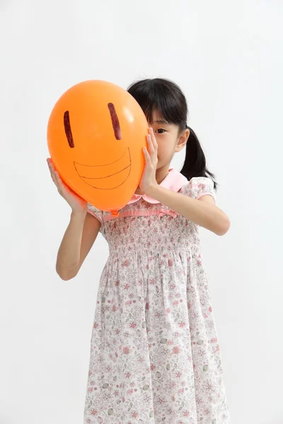 Chinese girl hide behind a balloon — Stock Photo, Image