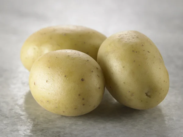 Potatoes on the marble table — Stock Photo, Image