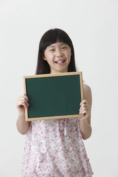 Girl holding blackboard — Stock Photo, Image