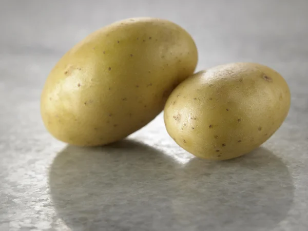 Potatoes on the marble table — Stock Photo, Image