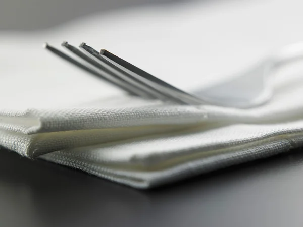 Tenedor en la servilleta en la mesa — Foto de Stock