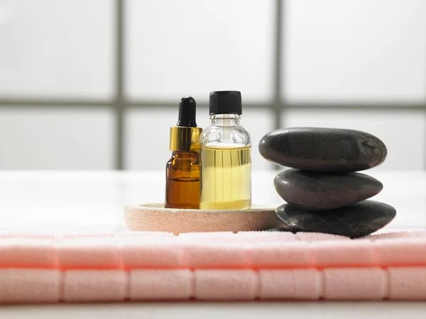 Stack of stone and massage oil — Stock Photo, Image