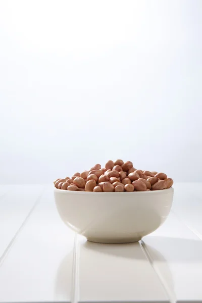 Ground nut in a white bowl — Stock Photo, Image