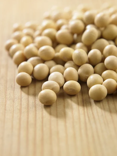 Soy beans on the wooden table — Stock Photo, Image