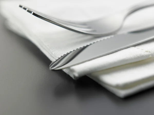 Fork and knife on the napkin on table — Stock Photo, Image