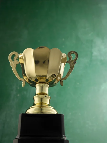 Gold trophy against black board — Stock Photo, Image