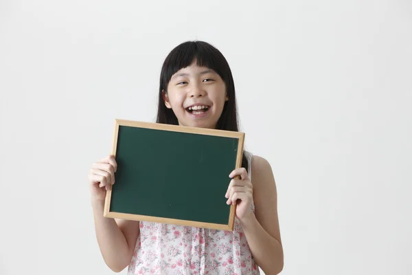 Girl holding blackboard — Stock Photo, Image