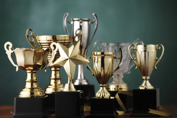 Group of the trophies on the green background — Stock Photo, Image