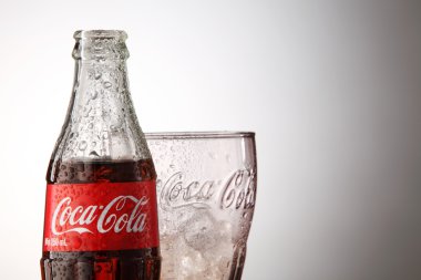 Bottle of Coca cola with glass