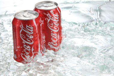 Coca cola cans with water splash