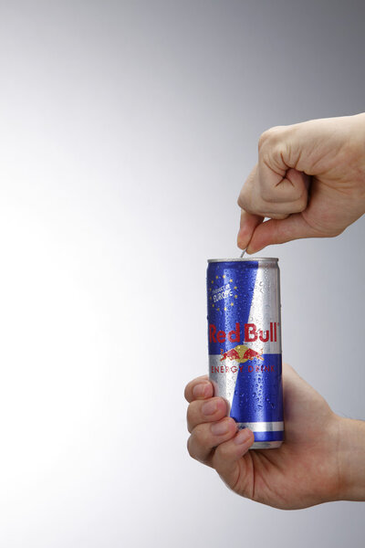 Man opening can of redbull