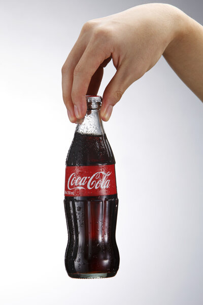 Hand holding coca cola