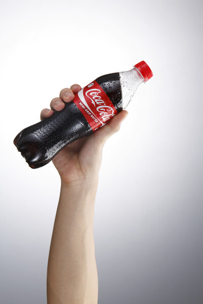 Hand holding coca cola