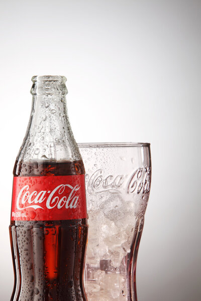 Bottle of Coca cola with glass