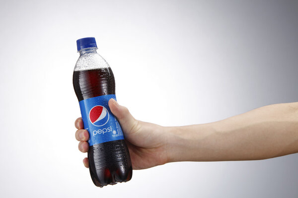 Hand holding Pepsi