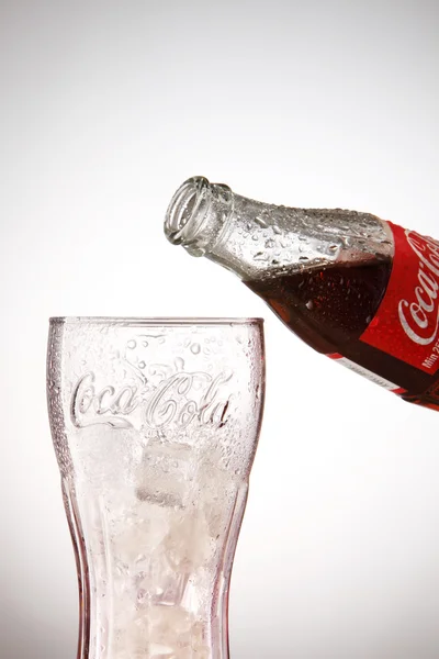 Bottle of Coca cola with glass — Stock Fotó