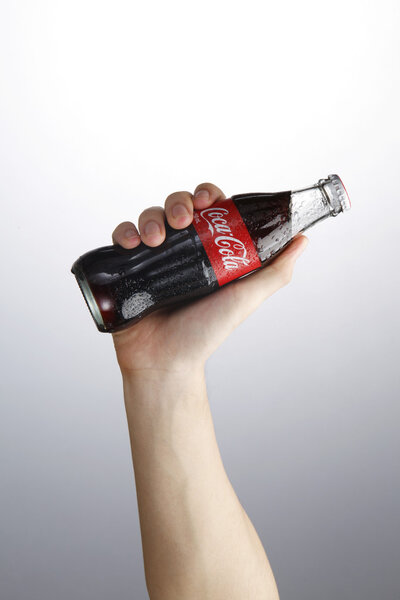 Hand holding coca cola