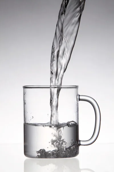 Pouring water into glass — Stock Photo, Image