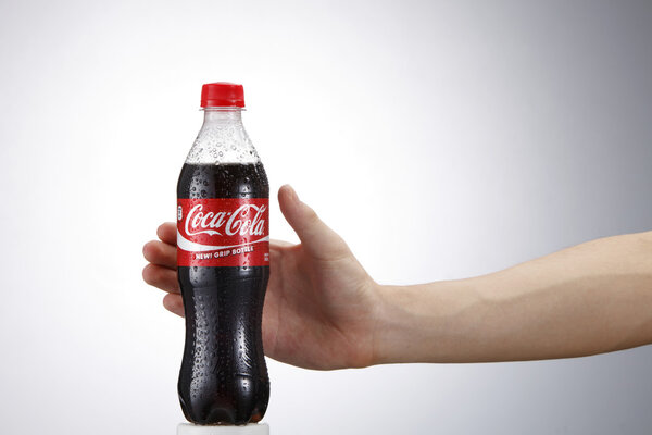 Hand holding coca cola