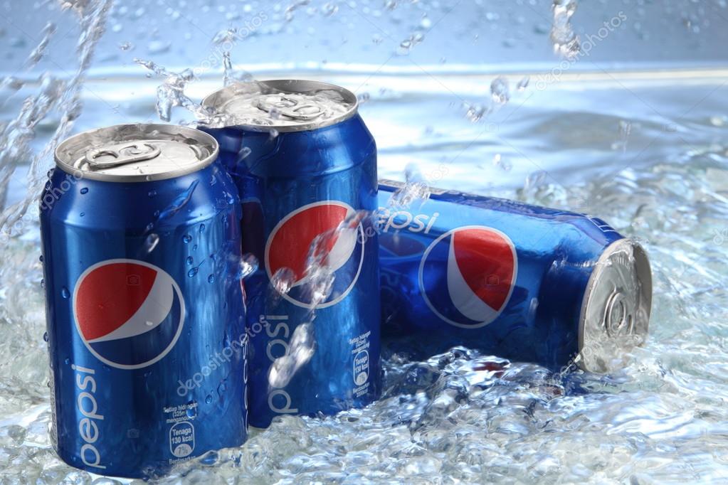 KUALA LUMPUR, MALAYSIA, APRIL 15, 2015: Cans of Pepsi cola on a bed of ice and white background, Pepsi is a carbonated soft drink produced PepsiCo. Created in 1893