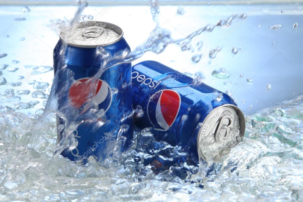 KUALA LUMPUR, MALAYSIA, APRIL 15, 2015: Cans of Pepsi cola on a bed of ice and white background, Pepsi is a carbonated soft drink produced PepsiCo. Created in 1893