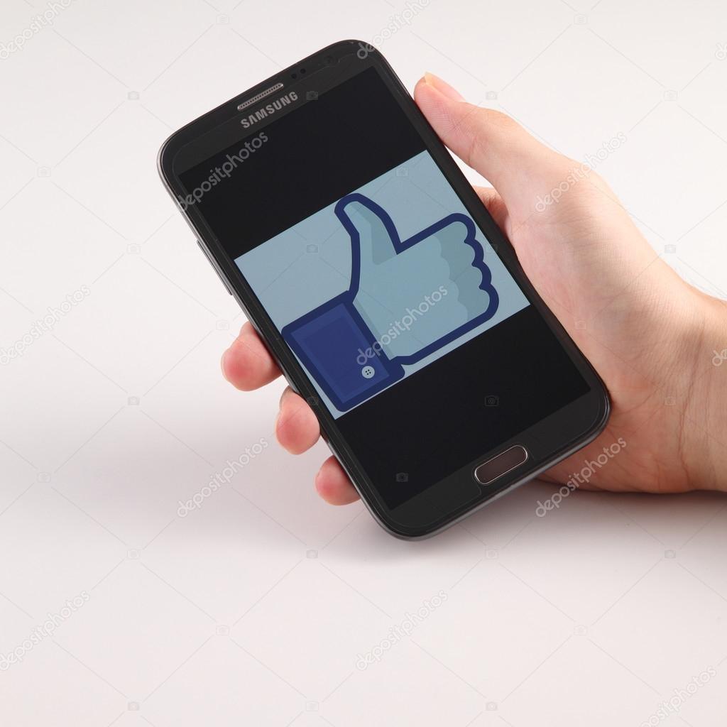KUALA LUMPUR, MALAYSIA,  MAY 14, 2015: Facebook application logo on smart Phoneon white  background. Facebook is largest and most popular social networking site in the world.