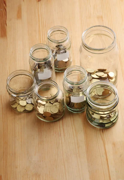 Coins in glass jars — Stock Photo, Image