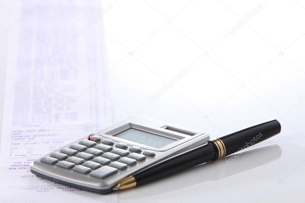 calculator and pen on white