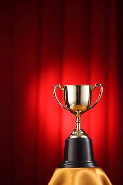 trophy in front of the red curtain clipart
