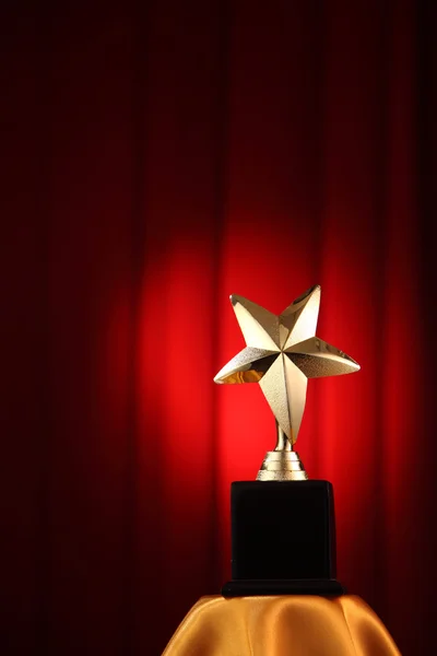 Trophy in front of the red curtain — Stock Photo, Image