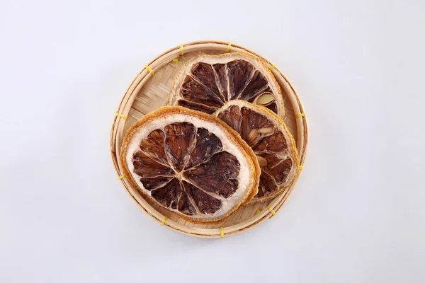 dried lemon slices in straw plate