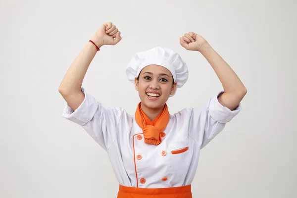 Donna in uniforme da chef con le mani in alto — Foto Stock