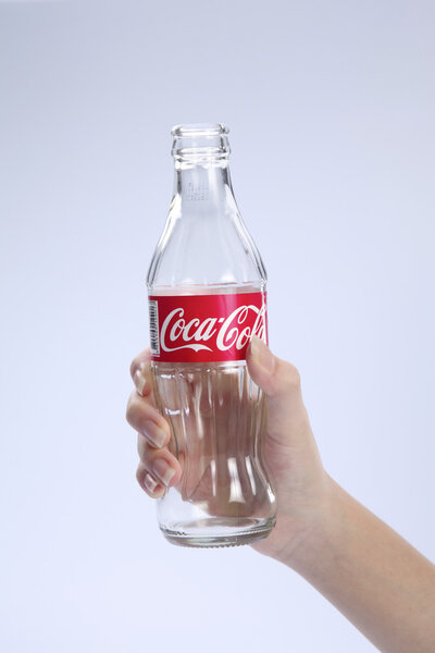 holding empty coca cola
