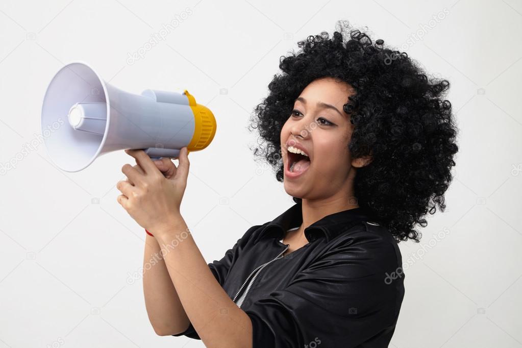 Indian girl in wig and with megaphone
