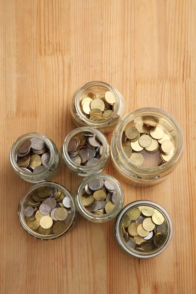 Coins in glass jars — Stock Photo, Image