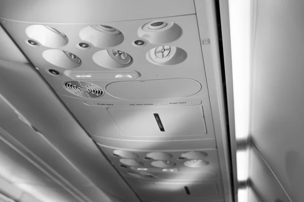 Italy, airplane cabine with the fasten belts and no smoking signs on — Stock Photo, Image