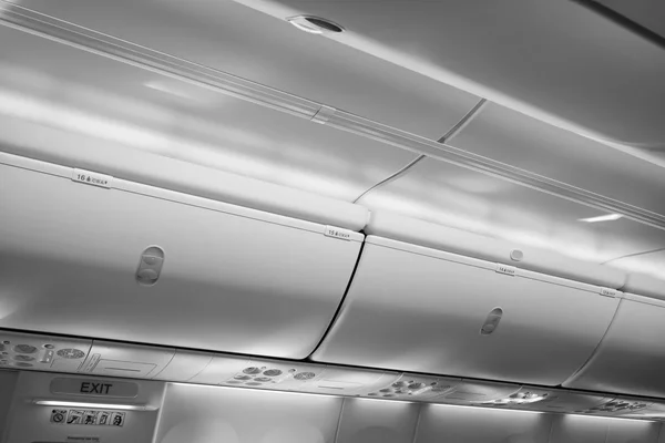 Italy, airplane cabin with the fasten belts and no smoking signs on — Stock Photo, Image