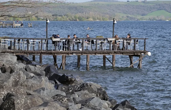 Italy, Lazio, Bracciano lake, Trevignano (Rome); 31 March 2016, people relaxing on a wooden pier by the lake - EDITORIAL — Stock Photo, Image