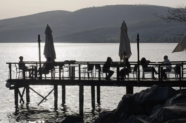 Italy, Lazio, Bracciano lake, Trevignano (Rome); 6 April 2016, people relaxing on a wooden pier by the lake - EDITORIAL — Stock Photo, Image